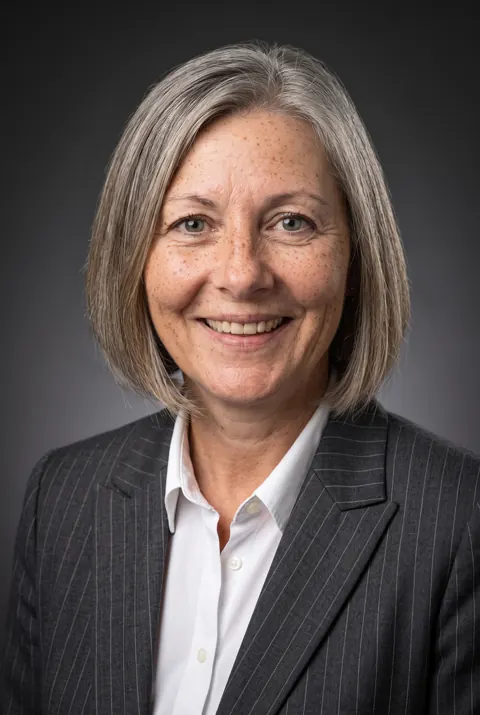 Example AI headshot, Finance Executive style (AI-generated person)